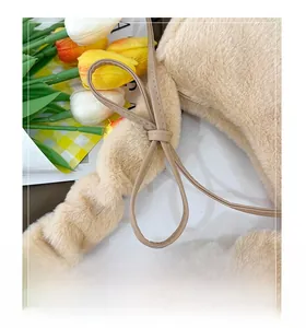 Close-up of plush faux fur handbag with drawstring detail and elegant side bow design