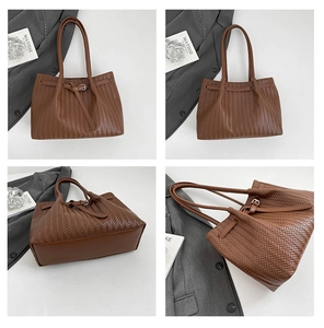 Detail view of brown woven tote bag with V-shaped texture and decorative buckle strap