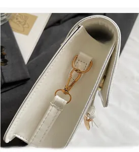 Close-up of premium white leather bag showing high-quality gold hardware and stitching