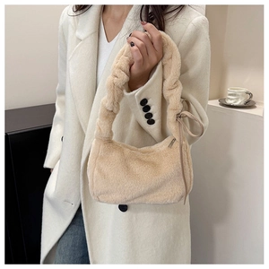 Detail of soft beige plush shoulder bag with trendy ruched cloud handle for winter style