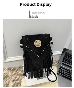 Detail of bohemian black bucket bag with golden studs, gem emblem, and fringe tassels
