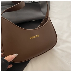 Close-up of coffee brown hobo crescent bag with golden Fashion & Bags logo print