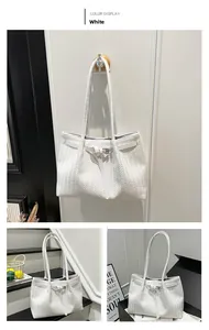 Detail shot of white woven tote bag showing premium V-pattern texture and buckle strap