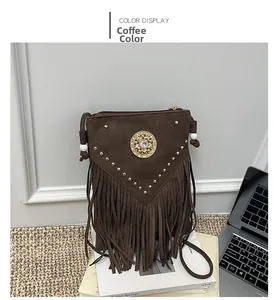Close-up of coffee brown faux suede bag featuring fringe and gold metal rivets