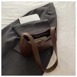 Detail view of the brown moon-shaped hobo bag showing its multiple inner compartments