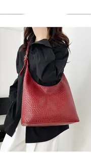 Detail showing the red woven texture and metal buckle on the large Hobo shoulder bag