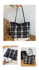 Detail of black and white checkered plush tote bag with leather straps and logo patch