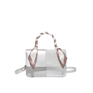 Silver patchwork leather handbag with decorative silk scarf on handle and shoulder strap