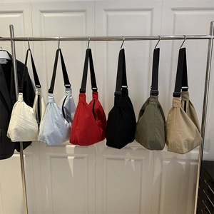 Lightweight nylon crossbody dumpling bags in six colors with adjustable black straps
