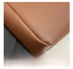 Macro detail of brown leather texture and precise stitching on the luxury shoulder bag