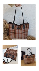 Detail of plaid tote bag with fashion tag, leather handles and vintage fabric texture
