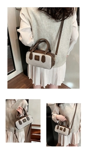 Detail of vintage beige canvas bowling bag with brown leather trim and metal hardware