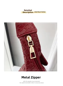 Macro view of burgundy tote bag with gold metal zipper and woven texture leather detail
