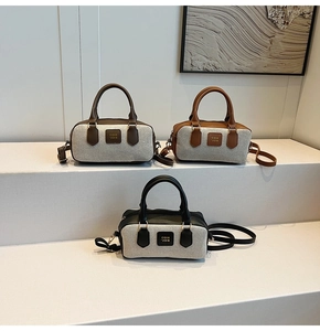 Three Boston bags in brown, beige and black displayed on minimalist white steps