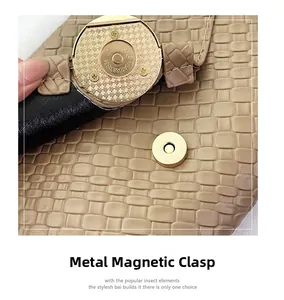 Detail of metallic magnetic closure with serial number on khaki woven leather bag