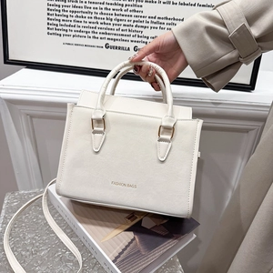 Minimalist white PU leather tote bag with gold lettering and adjustable shoulder strap