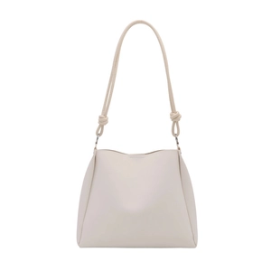 Minimalist creamy white leather bucket bag with knot details and silver rings