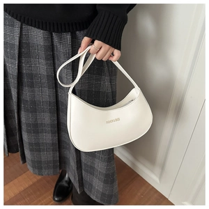 Detail of white crescent shoulder bag with gold Fashion & Bags lettering on matte leather