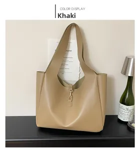 Close-up of khaki tote bag featuring fine grain texture and gold metal hook closure