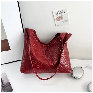 Detail of burgundy woven tote bag showing premium leather texture and intricate pattern