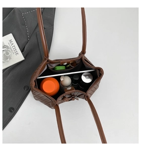 Top view of brown woven tote bag interior showing spacious storage for tablet and cup