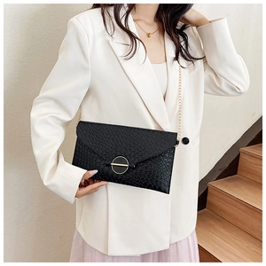 Chic black crocodile embossed leather crossbody bag with elegant gold ring buckle detail