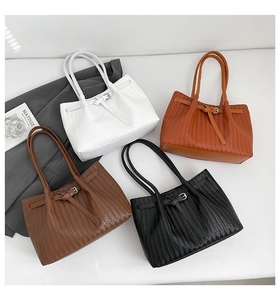 Detailed overhead view of woven leather tote bags in white, brown, coffee, and black