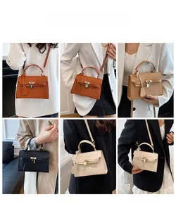 Detail of minimalist tote bags in four colors with textured finish and gold lock closure