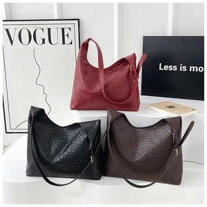 Three woven hobo tote bags in burgundy, black and brown on white minimalist steps