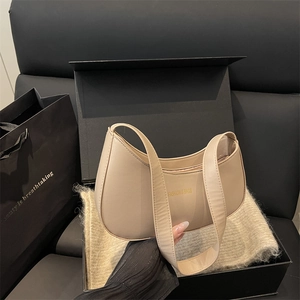 Minimalist beige half-moon hobo bag with gold lettering in a premium gift box set
