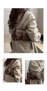 Dettaglio borsa marrone in pelle PU con borchie argentate e tracolla regolabile con occhielli