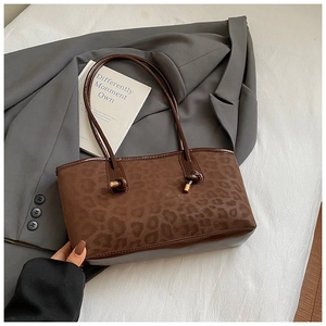 Dettaglio della borsa tote leopardata con trama in ecopelliccia e tracolla con nodi