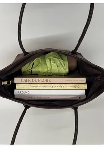 Top view of large capacity brown tote bag interior showing books and storage space