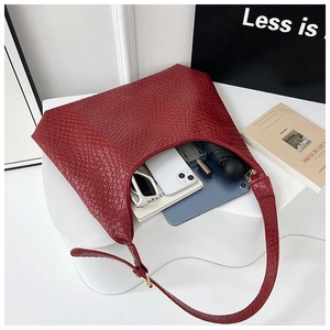 Close-up of red woven tote bag showing spacious interior with daily essentials and texture