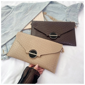 Detail showing woven texture and decorative buckle on small crossbody flap bags