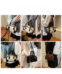 Detail of Boston handbag with color-block PU leather, top handles and striped scarf charm