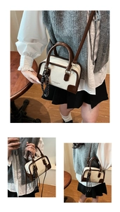 Detail of cream and brown contrast mini bag with silk scarf on a wooden table