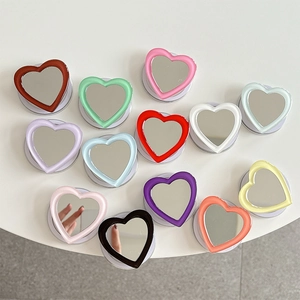 Collage of heart-shaped phone grip sockets with integrated mirrors in thirteen assorted colors