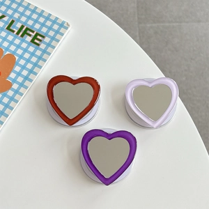 Mirror heart-shaped phone grip stand in red and purple colors with folding socket base
