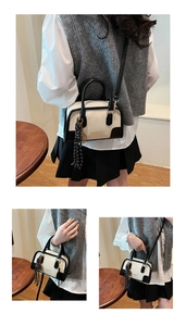 Detail of contrast Boston bag showing monochrome leather and checkered scarf ornament