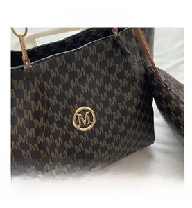 Detail of monogram pattern tote bag with gold metal M logo and round coin purse