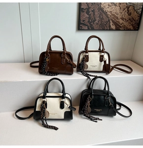 Boston style handbags in four colors featuring tennis racket charms and long straps