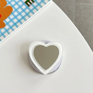 Macro detail of heart-shaped phone grip with mirror surface and translucent frame