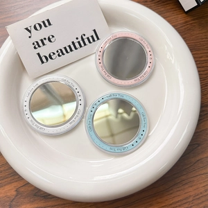 Three-piece set of mini round portable makeup mirrors in pink, white, and light blue colors