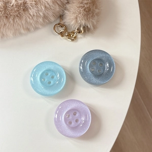 Glitter button-shaped phone grip stand in pastel blue and purple set for smartphones