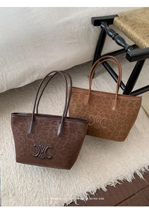 Macro detail of leopard print tote bags with embossed logo and suede leather texture