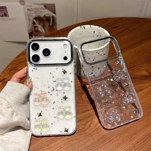 Sparkling cherry iPhone 16 Pro Max case with stars glitter on a wooden table