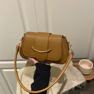 Brown crocodile pattern shoulder bag with a gold crescent buckle and slim strap