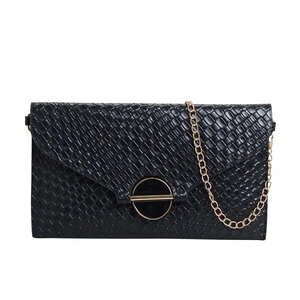 Elegant black woven envelope crossbody bag with circular gold lock and chain strap