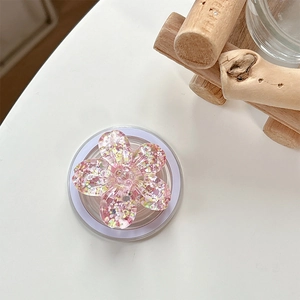 Close-up of a pink cherry blossom phone grip with glitter resin and flower design